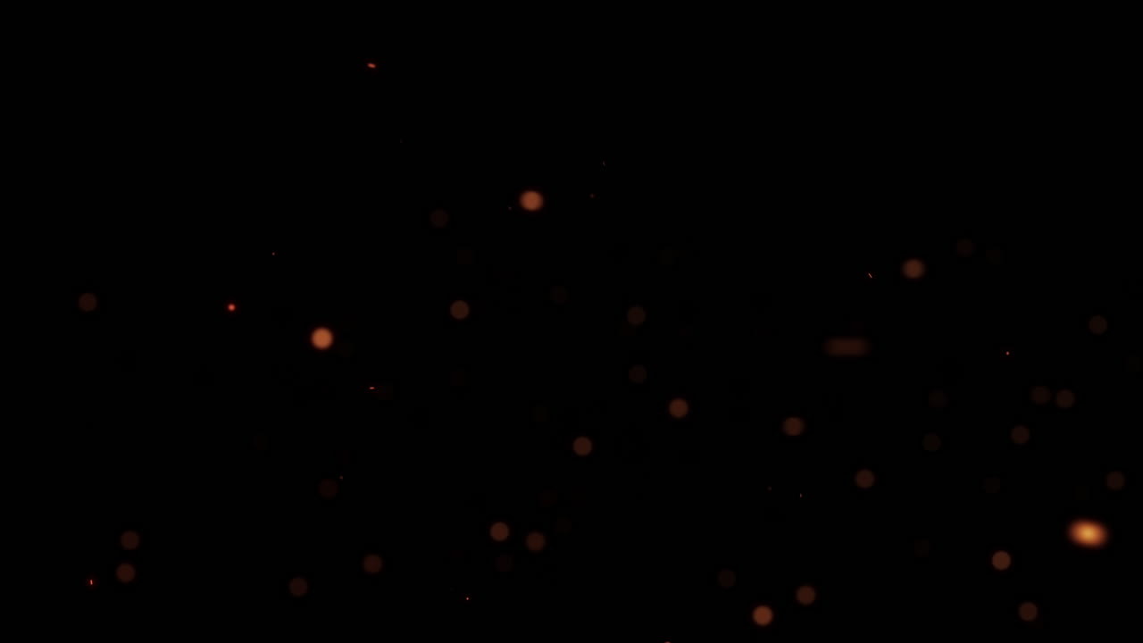 Partikel Berpijar Hangat dan Bokeh Melayang di Latar Belakang Hitam