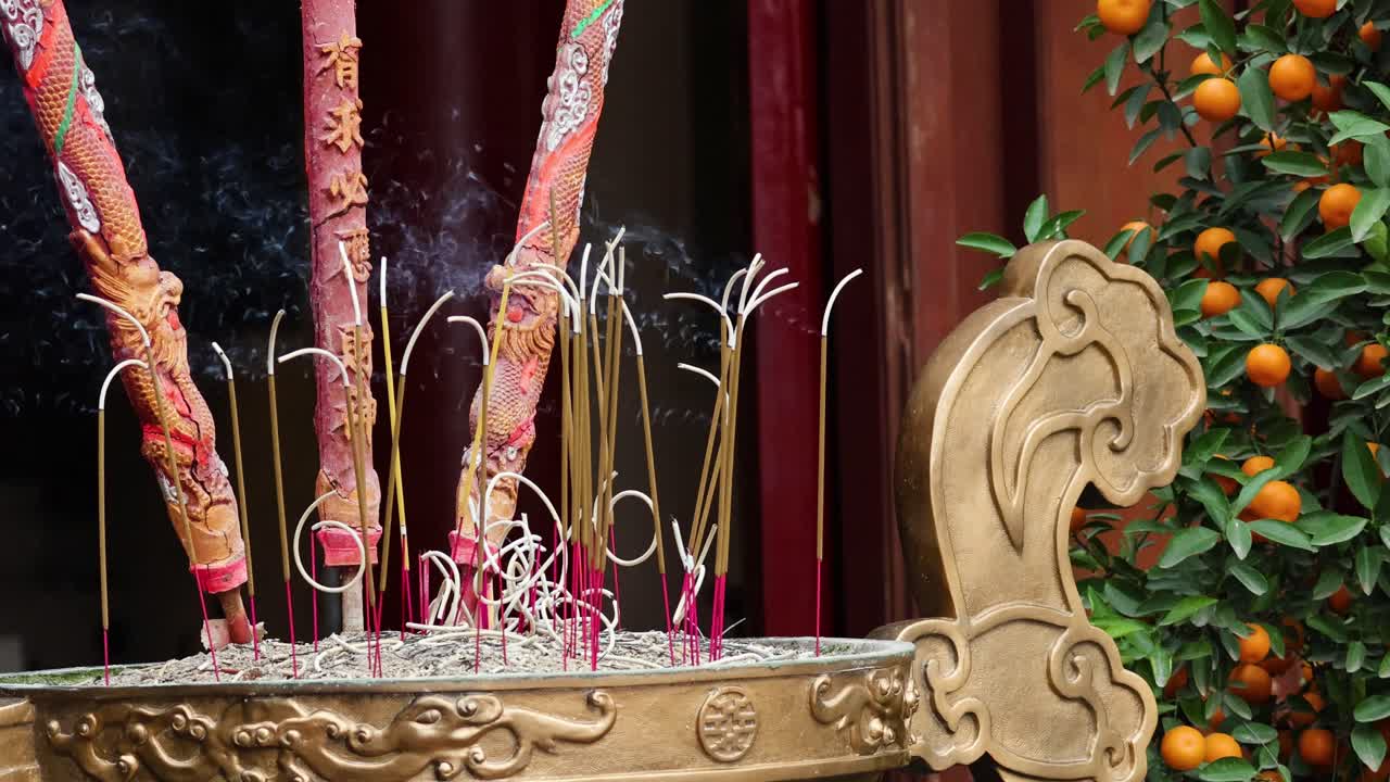 Incense sticks burning in a decorative holder