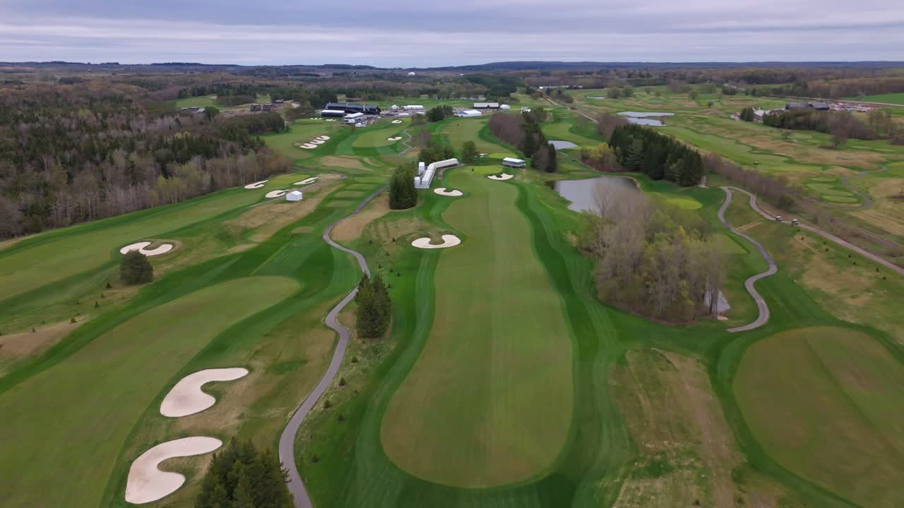 Aerial wide shot of TPC Toronto at Osprey Valley Golf Course In Alton Town, Caledon, Ontario, Canada. Neat grass and lawn of golf course. Wide shot.