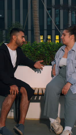 couple talking on a bench