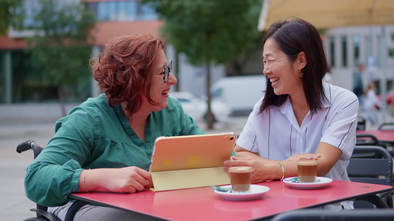 Two women enjoying coffee at an outdoor cafe