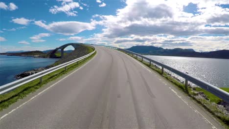 Driving-a-Car-on-a-Road-in-Norway-Atlantic-Ocean-Road-or-the-Atlantic-Road-(Atlanterhavsveien)-been-awarded-the-title-as-(Norwegian-Construction-of-the-Century).