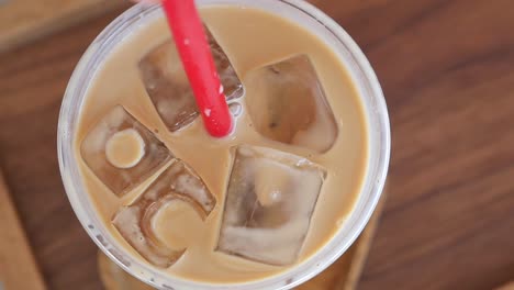 iced coffee in a plastic cup with a red straw