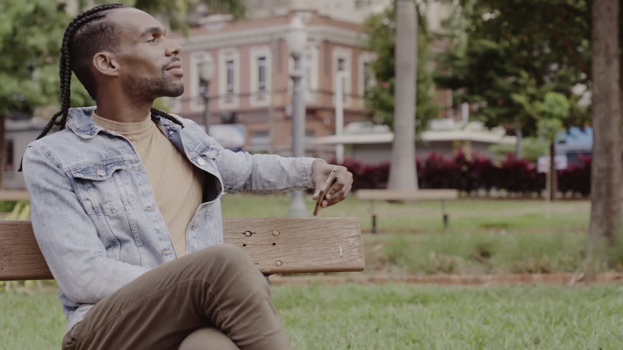A Young Man Relaxing on a Park Bench