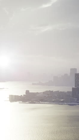 urban skyline glimmers under the soft glow of a dusky sun by the water