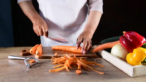 woman slicing carrots on the cutting board