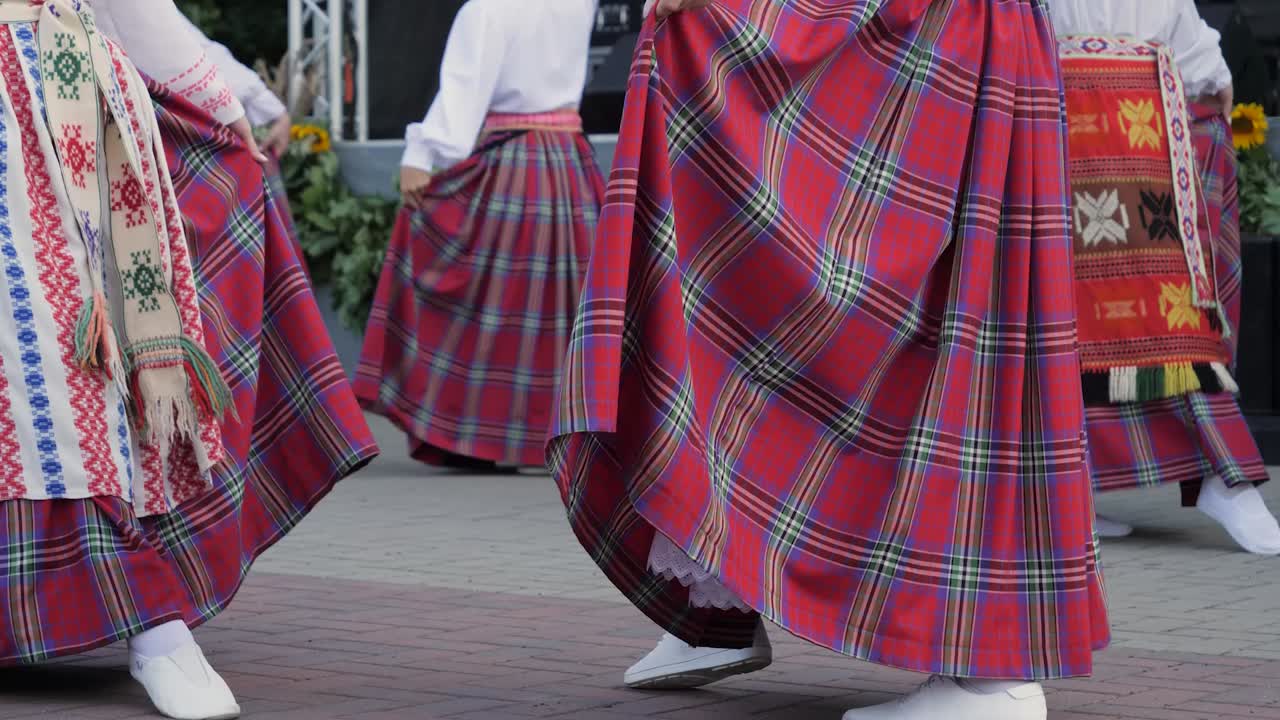 Woman dance with traditional Lithuanian clothes and hats