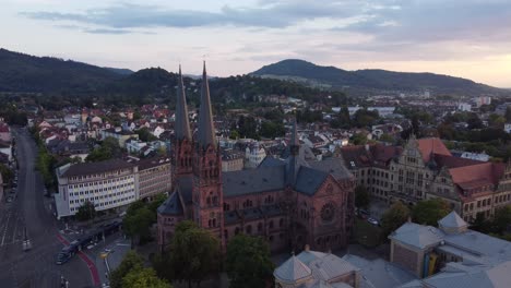 aerial view of catholic church johanneskirche in gothic old town of freiburg im breisgau during sunset, germany