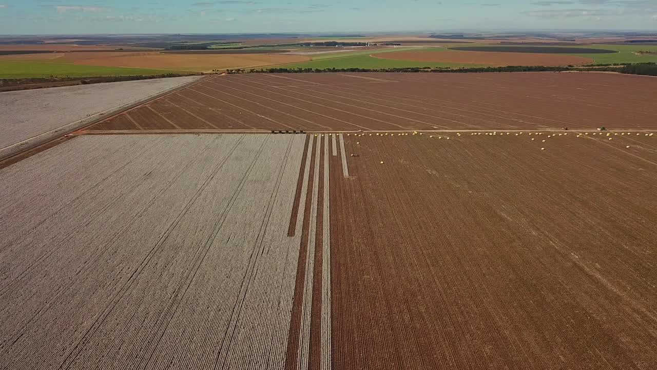 High altitude aerial shot of a partially harvested cotton field in rural Brazil