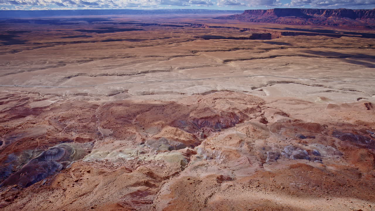 Stunning aerial footage of rocky spires and layered colors in the toadstool hoodoos region.