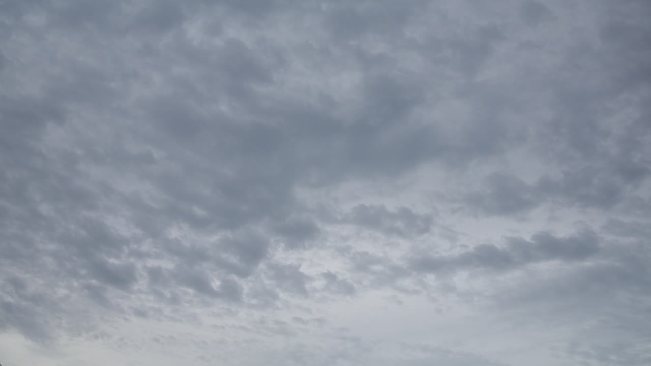 Storm clouds slowly forming across the sky in a moody time-lapse scene