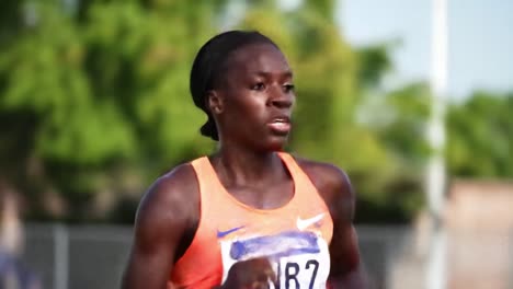 runner trains intensely on track for competition in warm weather