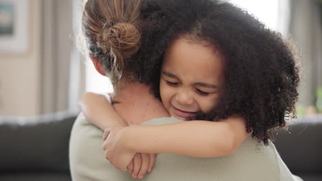 love, face and girl child hugging mother on a sofa