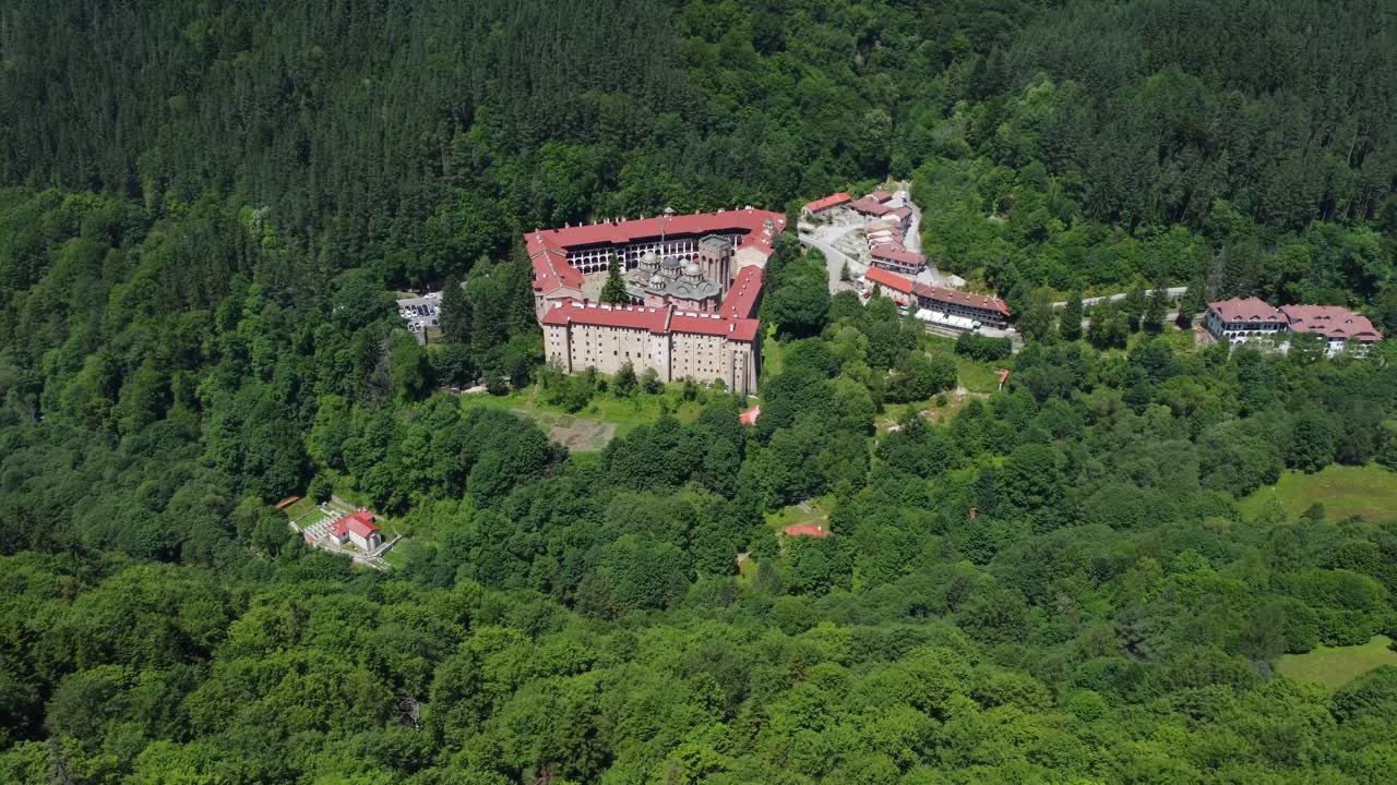 Cinematic drone video from above Rila Monastery amongst the forests of Rila Mountains, Bulgaria