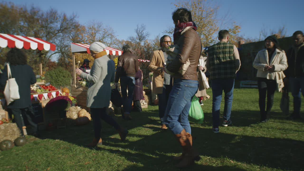 People Shopping on Urban Farmers Market People Shopping on Urban Farmers Market Choose Fresh Products Cares about Health and Spending Day off by Buys Proper Nutrition Autumn Fair Outdoors Agriculture