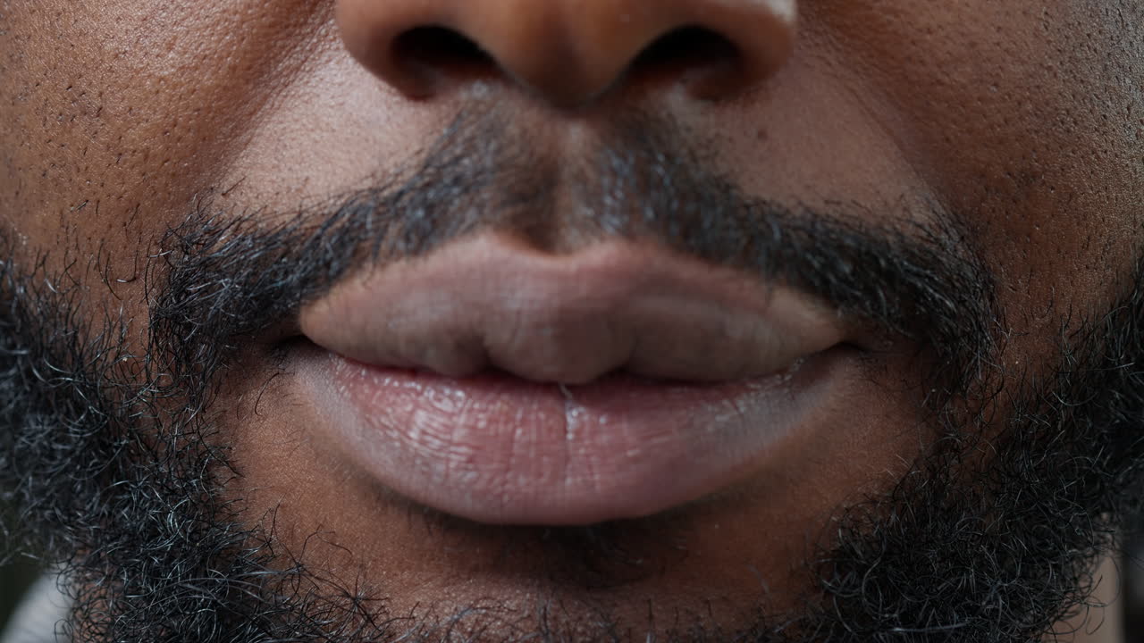 Macro shot of man moving his lips in front of camera