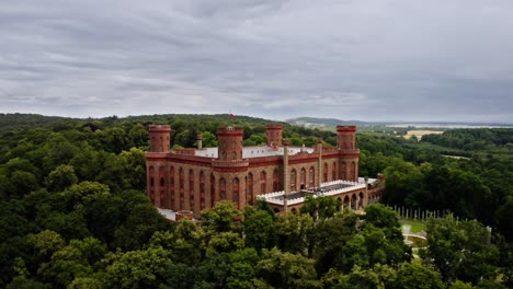 neo-gothic exterior of kamieniec zabkowicki palace with four corner towers