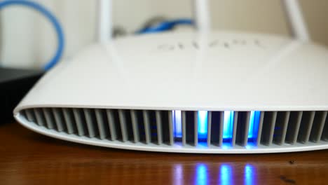 close-up of a white wireless router with blue led light