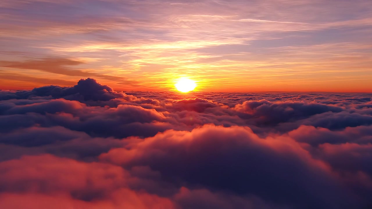 Golden sunrise shining over a thick sea of clouds