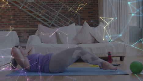 glowing network of connections against caucasian woman performing crunches exercise at home