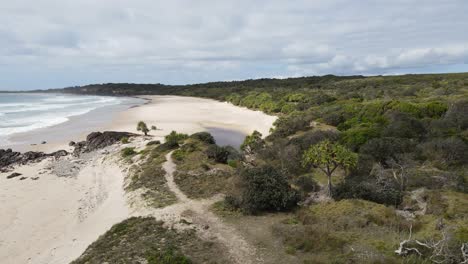 following a coastal walking track leading to a hidden waterhole close to an ocean beach