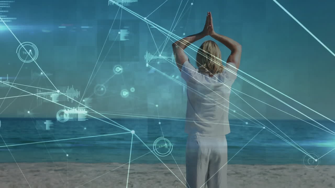 Practicing yoga on beach, person with digital network animation overlay