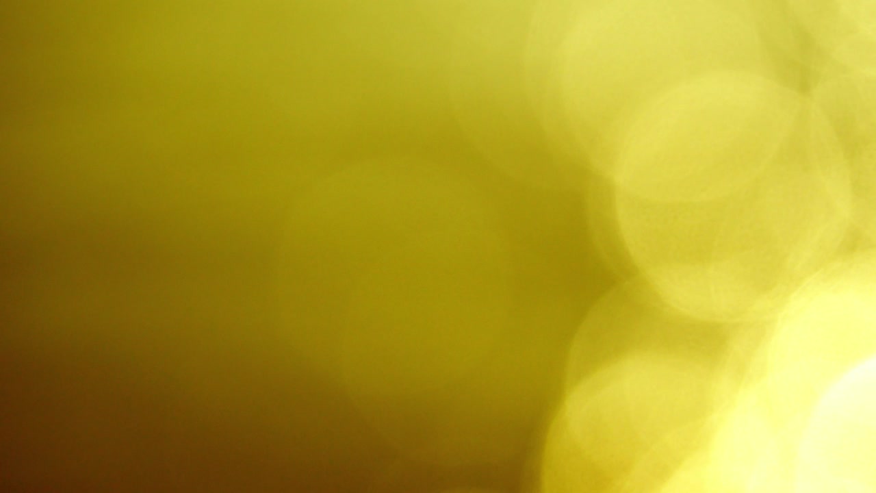 movimiento de brillo de color dorado círculo de iluminación en fondo marrón