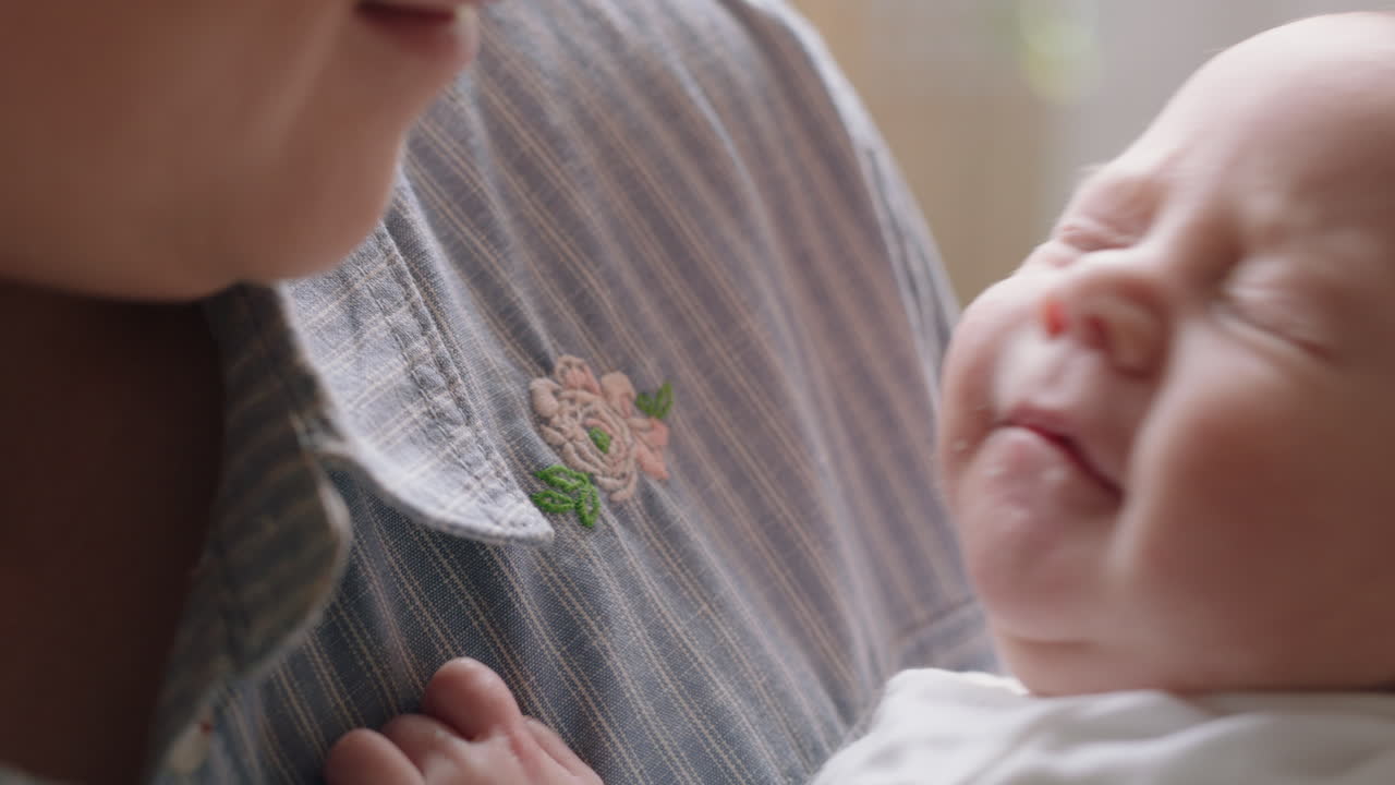 mother holding sleepy baby yawning tired newborn resting  with mom gently soothing infant nurturing child enjoying motherhood