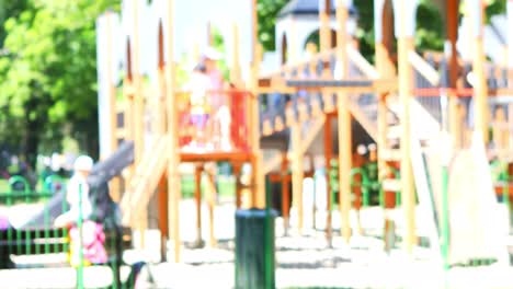 Stressed-young-woman,-mother-or-babysitter,-standing-next-to-playground