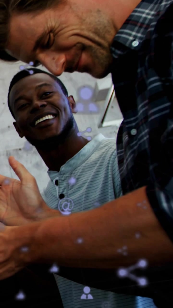 Vertical video: Presenter shifting phone sharing, team leaning in clapping, tech icons over device