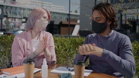 people washing hands outdoors at cafe