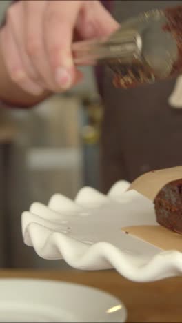 serving a portion of chocolate brownie cake