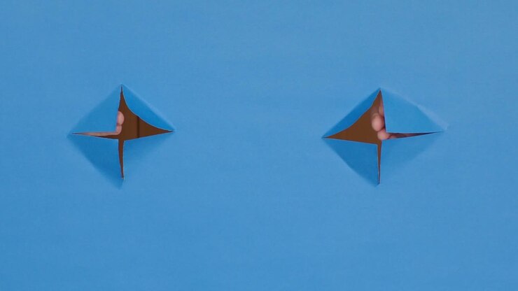 greeting hands through holes, on a blue background