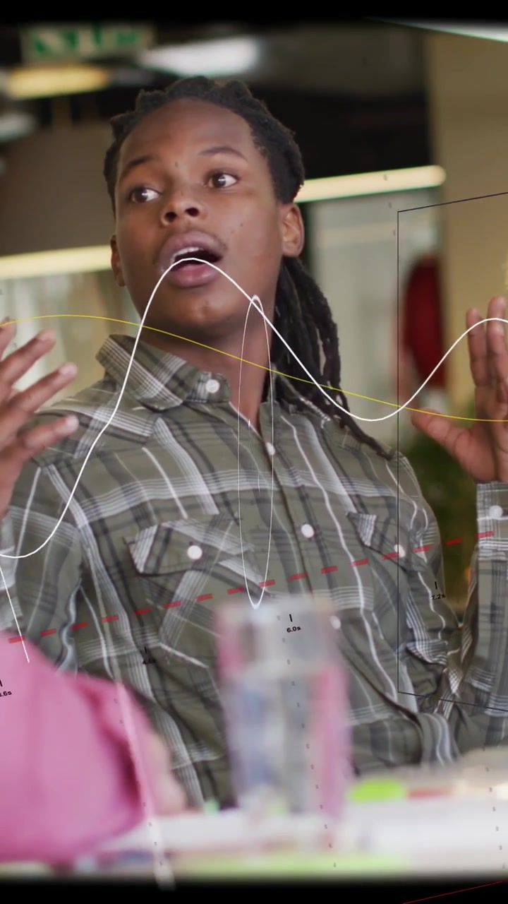 Vertical video: Man leading tech discussion, HUD overlay appearing and moving over chest and face