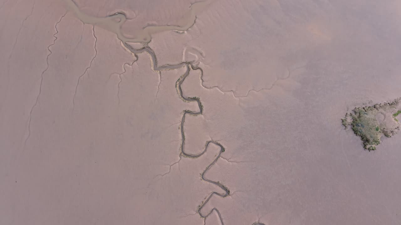 Maldon saltmarsh aerial view looking down over fractured estuary tidal mud flats on Essex marshland
