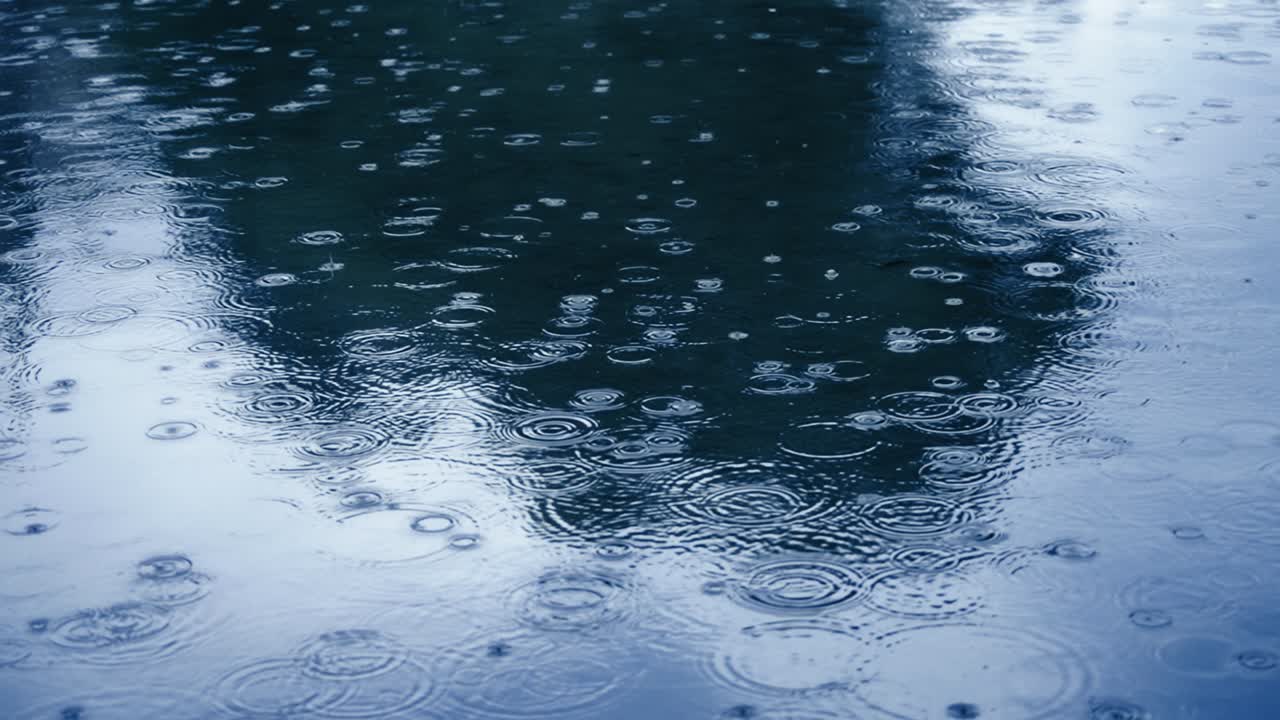 Rain drops of blue lake water surface