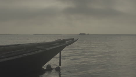 Boat-floating-in-the-calm-river-of-Bangladesh-while-sky-is-cloudy-4k-422-10-bit-stock-footage