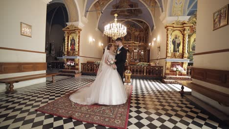 newlyweds. caucasian bride and groom together in an old church. wedding