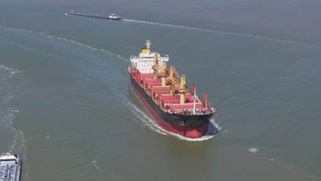 Big-cargo-vessel-cruising-at-Westerschelde-zeeland-during-sunny-day,-aerial