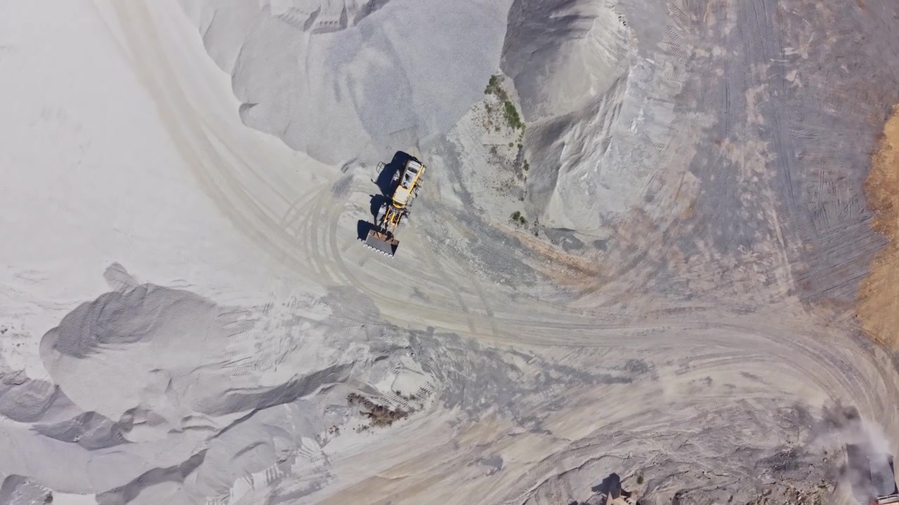 Granite quarry activity with trucks and machinery working in the extraction area