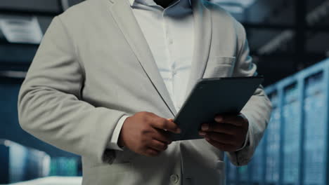 vertical video data center system administrator coding on tablet, doing software updates