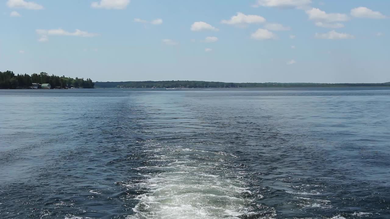 Wake of A Speedboat Sailing On The Calm Water During Summer In Kawartha Lakes In Ontario, Canada. - pan down