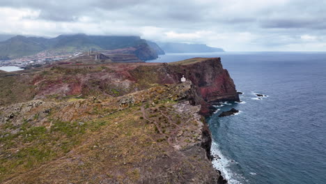 aerial over steep sheer sea cliffs and beacon at easternmost point of madeira