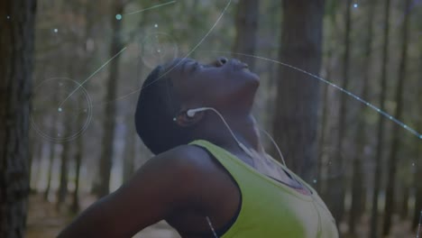 animation of network of connections over woman stretching exercising in forest