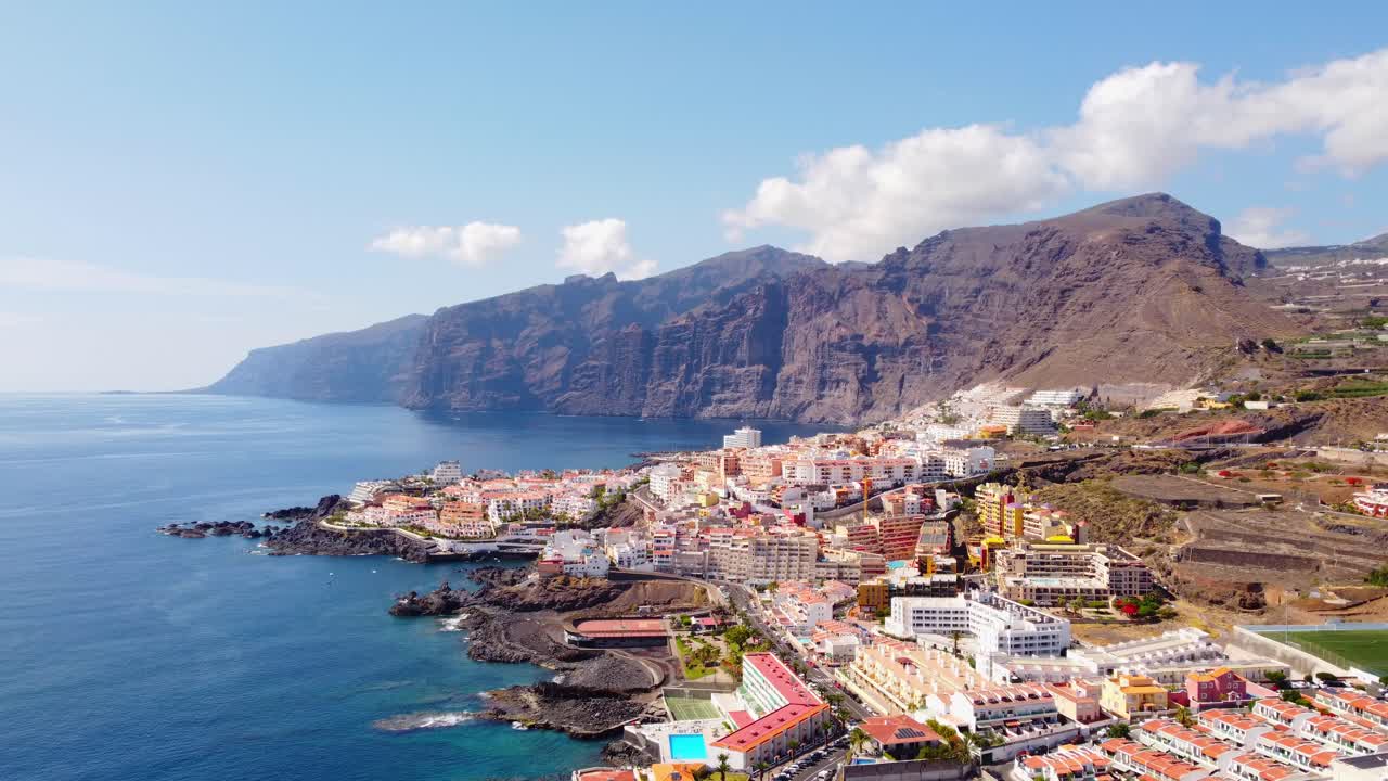 Drone shot revealing the town of Santiago del Teidea and Playa De La Arena beach on the west coast of Tenerife and Canary Island, Spain
