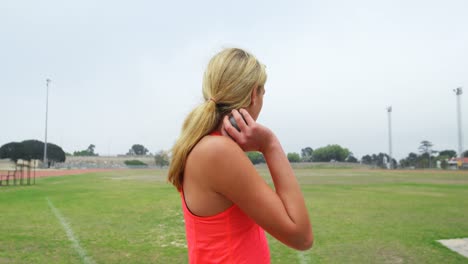 Side-view-of-young-Caucasian-female-athlete-getting-ready-for-shot-put-throw-4k