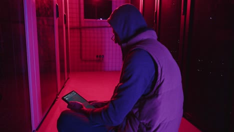 technician working in a dark server room at night