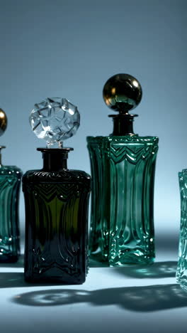 elegant ornate glass bottles and decanters in various colors
