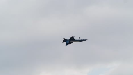 rcaf f-18 jet performs aileron roll with extended landing gear track