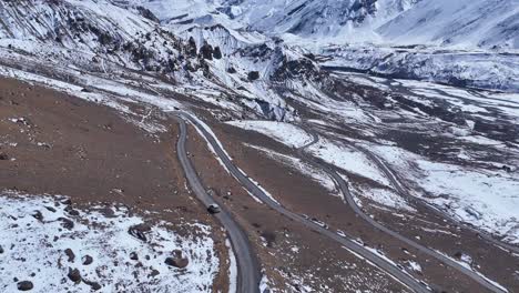 snowy mountain road with winding highway